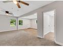 Spacious living room with carpet flooring and plenty of natural light flowing in from large windows at 3601 Avenue R Nw, Winter Haven, FL 33881