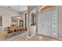 Elegant entryway showcasing tile floors, a stylish front door, and a glimpse into the dining area at 3980 Sunset Lake Dr, Lakeland, FL 33810