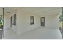 Side view of a newly renovated home showcasing its spacious covered carport area and exterior paint at 408 Sycamore Sw St, Fort Meade, FL 33841