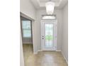Welcoming foyer featuring tiled floors, decorative door, and natural light at 4125 Prima Lago Cir, Lakeland, FL 33810