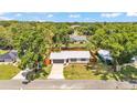Charming single-story home featuring a new metal roof, gray garage door and beautiful landscaping from above at 416 Bayou Rd, Winter Haven, FL 33884
