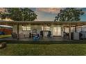 Spacious covered patio perfect for outdoor lounging and entertaining with stylish furniture and ceiling fans at 416 Bayou Rd, Winter Haven, FL 33884