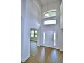 Dramatic two-story entryway showcasing tile floors, a modern light fixture, and ample natural light at 4312 Juliana Lake Dr, Auburndale, FL 33823