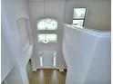 View from the second story down into the dramatic entryway with wood-look floors and soaring ceilings at 4312 Juliana Lake Dr, Auburndale, FL 33823