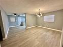 Bright living room featuring stylish lighting fixture and wood-look floors at 4535 Weston Ct, Bartow, FL 33830