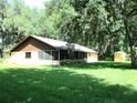 Spacious backyard featuring a screened lanai and storage shed at 5070 Ironwood Trl, Bartow, FL 33830