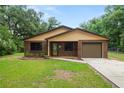 Charming one-story brick home boasting manicured front yard, and inviting entry, offering classic curb appeal at 5120 Lunn Rd, Lakeland, FL 33811