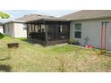 Private backyard with screened patio and green lawn at 550 Patton Loop, Bartow, FL 33830