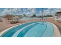 Inviting community pool and spa area with ample seating, perfect for relaxation and recreation on sunny days at 5920 Cormorant Ct, Lakeland, FL 33809