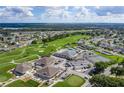 Panoramic aerial view of the community, showcasing lush landscaping, golf course, pool, and amenities at 5976 Cormorant Ct, Lakeland, FL 33809