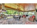 Enjoy this screened-in patio, outdoor kitchen, and seating areas with a view at 6475 Avalon Woods Dr, Lakeland, FL 33813