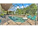 Screened-in pool with lake views, deck area, and outdoor seating; perfect for relaxing at 6475 Avalon Woods Dr, Lakeland, FL 33813