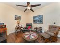 Cozy living room features hardwood floors, ceiling fan and comfortable seating arrangement at 6789 Ashbury Dr, Lakeland, FL 33809