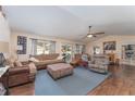 Spacious living room features wood floors, plush seating, and a ceiling fan at 6789 Ashbury Dr, Lakeland, FL 33809