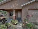 Inviting front porch with brick columns and mature landscaping in front of this home at 829 N Lake Ave, Lakeland, FL 33801