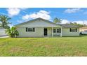 Inviting single-story home featuring a well-maintained lawn and covered front porch seating area at 934 Point View Ln, Lakeland, FL 33813