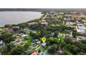 An aerial view of the home nestled in a lush, green neighborhood near a lake at 941 Avon Ave, Lakeland, FL 33801