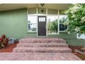 Inviting front entrance with brick steps and a large picture window at 941 Avon Ave, Lakeland, FL 33801