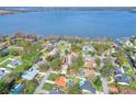 Aerial view of lakeside community showcases waterfront homes and lush landscaping near a big lake at 1118 Cypress W Pt, Winter Haven, FL 33884