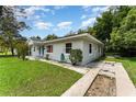 Quaint single-story home with lush landscaping and well-kept lawn at 1125 Josephine St, Lakeland, FL 33815