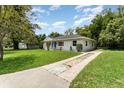 Charming single-story home with well-manicured lawn and long driveway at 1125 Josephine St, Lakeland, FL 33815