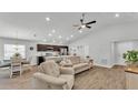 Open-concept living room and kitchen area with ample natural light and views of the dining area at 122 St Thomas Dr, Mulberry, FL 33860