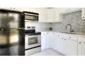 Efficient kitchen featuring stainless steel appliances and white cabinetry at 124 Carolyn Dr, Lakeland, FL 33803