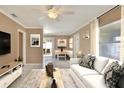 Bright living room featuring a comfortable white couch and neutral decor at 124 Carolyn Dr, Lakeland, FL 33803