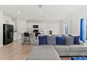 Cozy living room area features an open concept with a kitchen, island with bar seating at 1371 Madison Cir, Haines City, FL 33844