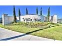 Beautiful monument sign for Villa Mar with manicured landscaping and clear blue skies at 1521 Leamington Ln, Winter Haven, FL 33884