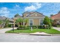 Lovely home showcases meticulous landscaping, mature palms, and a manicured lawn, enhancing curb appeal at 1739 Laurel Glen Pl, Lakeland, FL 33803