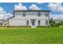 Charming two-story townhouse featuring a well-kept lawn and inviting light-blue front door at 1754 Sanibel Dr, Davenport, FL 33896
