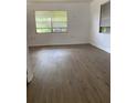 Bright bedroom featuring laminate flooring and natural light from large windows at 1820 Salem Rd, Lakeland, FL 33803