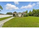Charming single-story home with a well-manicured lawn under a bright, blue sky at 1820 Salem Rd, Lakeland, FL 33803