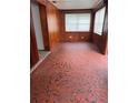 Cozy living room with unique tile flooring, wood paneled walls, and natural light at 1820 Salem Rd, Lakeland, FL 33803