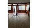 Bright living room with laminate flooring, wood paneled walls, and natural light at 1820 Salem Rd, Lakeland, FL 33803