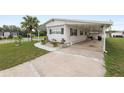 The home features an attached carport, offering convenient covered parking and protection from the elements at 1823 Blue Lake Dr, Lakeland, FL 33801