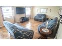 Cozy living room featuring tile flooring, large windows, and comfortable furniture at 2170 Forest Lake Ave, Dundee, FL 33838