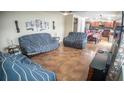 Spacious living room with tile flooring that opens into a dining and kitchen area at 2170 Forest Lake Ave, Dundee, FL 33838