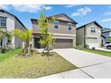 View of a two-story home with a well-maintained lawn and landscaping at 2244 Teneroc Trl, Lakeland, FL 33801