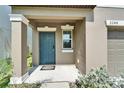 A close-up of the front door featuring a blue door and a window at 2244 Teneroc Trl, Lakeland, FL 33801