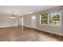 Bright, spacious living room with hardwood floors, showcasing an open layout and natural light from a large window at 2632 Handley Blvd, Lakeland, FL 33803