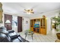 Bright living room featuring a comfortable sofa, a wooden entertainment center, and a view of the entryway at 322 Ne 9Th St, Mulberry, FL 33860