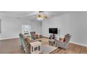 Spacious living room with neutral walls, hardwood floors, and comfortable seating at 535 N Todhunter Way, Lake Alfred, FL 33850