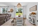 Cozy dining area with natural lighting and a farmhouse-style wooden table that is perfect for Gathering meals at 546 Scott Lake Creek Ln, Lakeland, FL 33813
