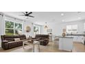 Bright living room featuring hardwood floors, large windows, comfortable seating, and an open concept design at 546 Scott Lake Creek Ln, Lakeland, FL 33813