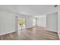 Bright living room with wood-look flooring and sliding glass doors leading to the lanai at 6 Rosewood Dr, Davenport, FL 33837