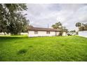 Expansive backyard of single-story home, offering plenty of room for outdoor activities and gardening at 6134 Christina E Dr, Lakeland, FL 33813