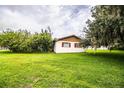 Cozy single-story home with an expansive green backyard and mature trees offering ample shade at 6134 Christina E Dr, Lakeland, FL 33813