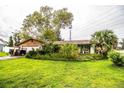 Inviting single-story home with a well-maintained lawn and beautiful mature shade trees at 6134 Christina E Dr, Lakeland, FL 33813